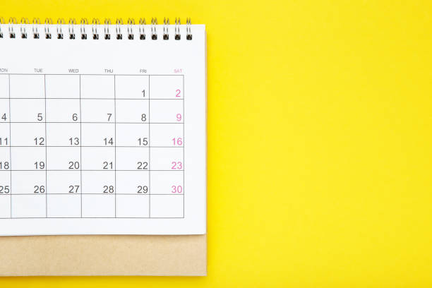 istock Paper calendar page on yellow background 2148184197