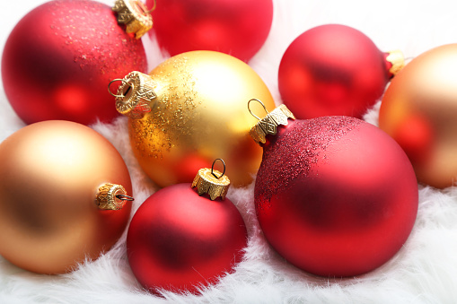 Red and golden christmas baubles on white background