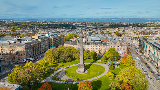 Aerial view of St.Andrew Square and Edinburgh old town, Aerial view of Saint Andrews Square in Edinburgh, Park in Edinburgh city center, Aerial view of Edinburgh old town

Edinburgh is the capital city of Scotland and one of its 32 council areas. The city is located in south-east Scotland, and is bounded to the north by the Firth of Forth estuary and to the south by the Pentland Hills. Edinburgh had a population of 506,520 in mid-2020, making it the second-most populous city in Scotland and the seventh-most populous in the United Kingdom.

St Andrew's Square is a garden square located at the east end of George Street in Edinburgh, Scotland.
Construction of St Andrew Square began in 1772 as the first part of the New Town, designed by James Craig. Within six years of its completion, St Andrew Square had become one of the most desirable and fashionable residential areas in the city. As the 19th century drew to a close, St Andrew Square became the commercial center of the city.
Much of the square consisted of large offices of banks and insurance companies, making it one of Scotland's largest financial centres. Once upon a time, St Andrew's Square could claim to be the wealthiest area of its size in all of Scotland.