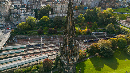 Aerial view of Edinburgh Scott monument, aerial view of the Scott Monument located in the Old Town and Princess Street in Edinburgh, Scott Monument in Edinburgh city centre, Gothic Revival architecture in Scotland, A Victorian Gothic monument to the Scott\n\nThe Scott Monument is a Victorian Gothic monument to the Scottish writer Sir Walter Scott. It is the second largest monument to a writer in the world, after the José Martí monument in Havana. It is located in Edinburgh's Princes Street Gardens, opposite the former Jenners building on Princes Street and close to Edinburgh Waverley Railway Station, named after Scott's Waverley novels.\n\nEdinburgh is the capital city of Scotland and one of its 32 council areas. The city is located in south-east Scotland, and is bounded to the north by the Firth of Forth estuary and to the south by the Pentland Hills. Edinburgh had a population of 506,520 in mid-2020, making it the second-most populous city in Scotland and the seventh-most populous in the United Kingdom.