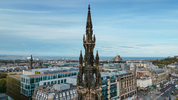 Aerial view of Edinburgh Scott monument, aerial view of the Scott Monument located in the Old Town and Princess Street in Edinburgh, Scott Monument in Edinburgh city centre, Gothic Revival architecture in Scotland, A Victorian Gothic monument to the Scott
The Scott Monument is a Victorian Gothic monument to the Scottish writer Sir Walter Scott. It is the second largest monument to a writer in the world, after the José Martí monument in Havana. It is located in Edinburgh's Princes Street Gardens, opposite the former Jenners building on Princes Street and close to Edinburgh Waverley Railway Station, named after Scott's Waverley novels.
Edinburgh is the capital city of Scotland and one of its 32 council areas. The city is located in south-east Scotland, and is bounded to the north by the Firth of Forth estuary and to the south by the Pentland Hills. Edinburgh had a population of 506,520 in mid-2020, making it the second-most populous city in Scotland and the seventh-most populous in the United Kingdom. aerial view of edinburgh scott monument, aerial view of the scott monument located in the old town and princess street in edinburgh, scott monument in edinburgh city centre, gothic revival architecture in scotland, a victorian gothic monument to the scott