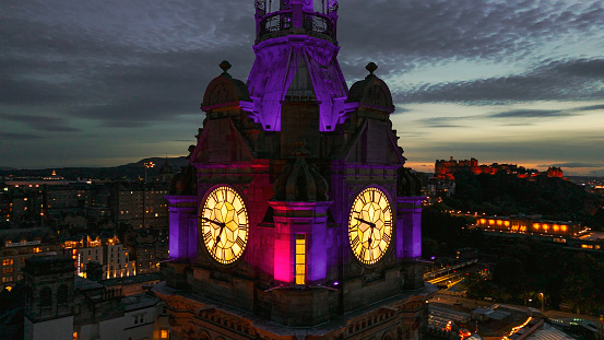 Aerial view of clock tower and scottish flag in Edinburgh old town, Aerial view of Old building in Edinburgh, Edinburgh city centre, Gothic Revival architecture in Scotland, Flag of Scotland in Edinburgh, Edinburgh city scotland at night\n\nEdinburgh is the capital city of Scotland and one of its 32 council areas. The city is located in south-east Scotland, and is bounded to the north by the Firth of Forth estuary and to the south by the Pentland Hills. Edinburgh had a population of 506,520 in mid-2020, making it the second-most populous city in Scotland and the seventh-most populous in the United Kingdom.