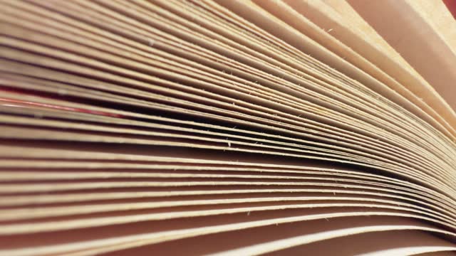 Texture of book pages with slight movement, extreme close-up.