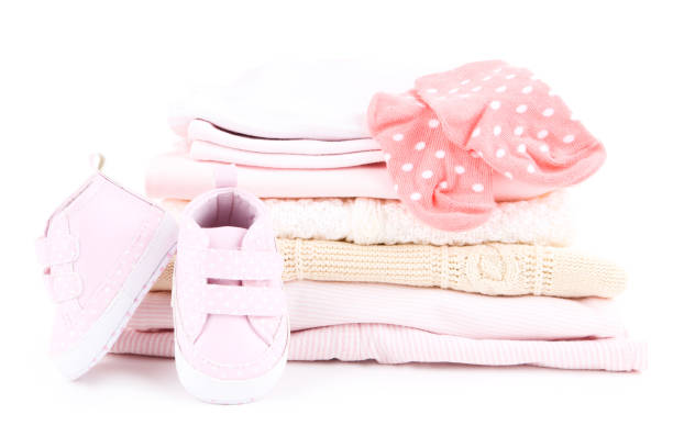 istock Different folded baby clothes with pair of shoes isolated on white background 2148187294