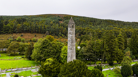 Aerial view of Glendalough ruins in Wicklow Ireland, Aerial view of Glendalough monastery, aerial view of Glendalough upper and lower lakes in Ireland, aerial view of ireland nature, popular tourist destination in Ireland\n\nGlendalough is a glacial valley in County Wicklow, Ireland, renowned for an Early Medieval monastic settlement founded in the 6th century by St Kevin. From 1825 to 1957, the head of the Glendalough Valley was the site of a galena lead mine. Glendalough is also a recreational area for picnics, for walking along networks of maintained trails of varying difficulty, and also for rock climbing.