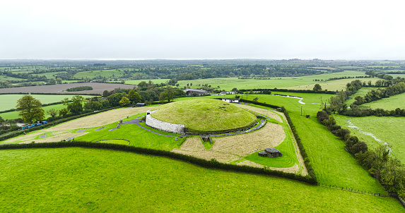 Newgrange is a prehistoric monument in County Meath in Ireland, located on a rise overlooking the River Boyne, 8 kilometres (5.0 mi) west of the town of Drogheda. It is an exceptionally grand passage tomb built during the Neolithic Period, around 3200 BC, making it older than Stonehenge and the Egyptian pyramids. Newgrange is the main monument in the Brú na Bóinne complex, a World Heritage Site that also includes the passage tombs of Knowth and Dowth, as well as other henges, burial mounds and standing stones.