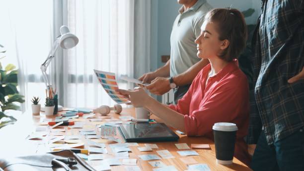 istock Smart manager working together with businessman choosing logo design. Symposium. 2148188724