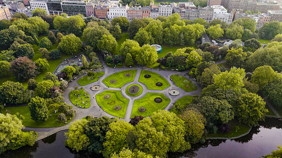 Aerial view of St Stephens Green park, Famous city parks in europe, popular tourist destination in ireland, aerial view of St Stephens Green public park Dublin Merrion Square

St Stephen's Green is a garden square and public park in Dublin, Ireland. The park's current landscaping was designed by William Sheppard. It was officially reopened to the public by Lord Ardilaun on Tuesday 27 July 1880. The square is adjacent to Grafton Street, one of Dublin's main shopping streets, and a shopping center named after it; In the surrounding streets, there are offices of various public institutions and a stop of one of Dublin's Luas tram lines. . It is often informally referred to as Stephen's Green. At 22 acres (8.9 ha), it is the largest of the parks in Dublin's main Georgian garden squares. Others include nearby Merrion Square and Fitzwilliam Square.
The park is rectangular and surrounded by streets that once formed major traffic arteries through Dublin city centre, but traffic management changes implemented in 2004 during the Luas works have greatly reduced traffic volumes. These four neighboring streets are called St Stephen's Green North, St Stephen's Green South, St Stephen's Green East and St Stephen's Green West respectively.