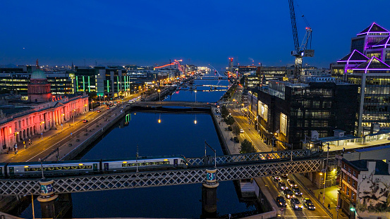 Aerial view of busy city center buildings and traffic at night, Aerial view of the river Liffey and city center Dublin Ireland at night, Aerial view of Dublin skyline and Samuel Beckett Bridge, Aerial view of Dublin city at night, Ireland\n\nDublin, pronounced is the capital and largest city of Ireland. On a bay at the mouth of the River Liffey, it is in the province of Leinster, bordered on the south by the Dublin Mountains, a part of the Wicklow Mountains range. At the 2016 census it had a population of 1,173,179, while the preliminary results of the 2022 census recorded that County Dublin as a whole had a population of 1,450,701, and that the population of the Greater Dublin Area was over 2 million, or roughly 40% of the Republic of Ireland's total population.