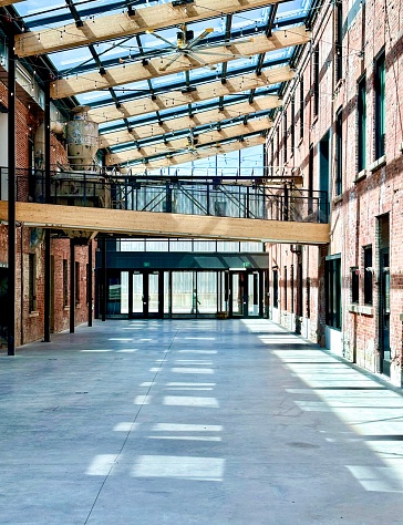 Repurposed turn of the century brick buildings attached by a glass ceiling and suspended walkways.