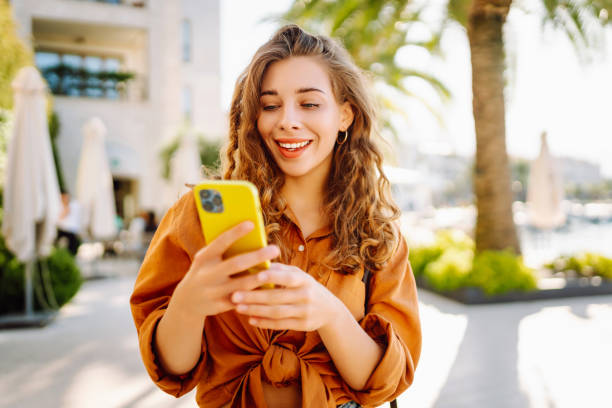 istock Young woman using smartphone at street. 2148191108