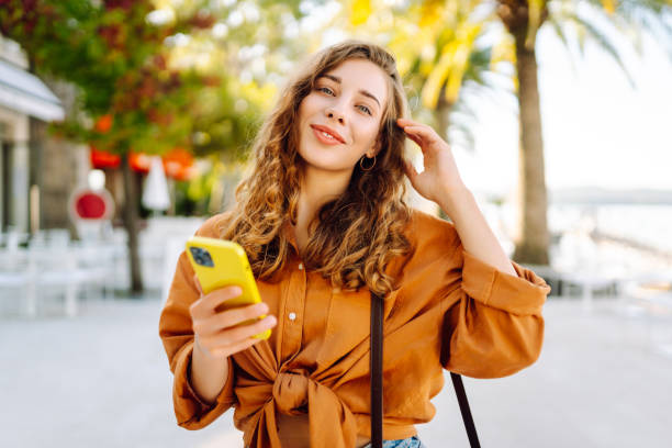 istock Young woman using smartphone at street. 2148191123