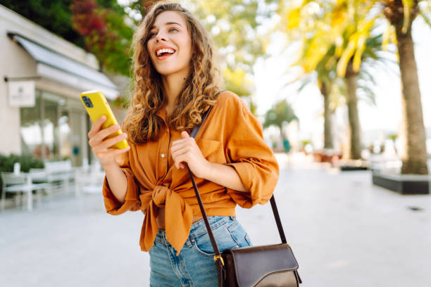 istock Young woman using smartphone at street. 2148191125
