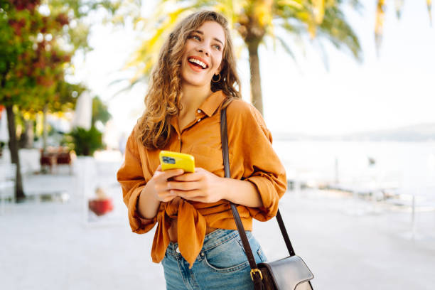 istock Young woman using smartphone at street. 2148191156