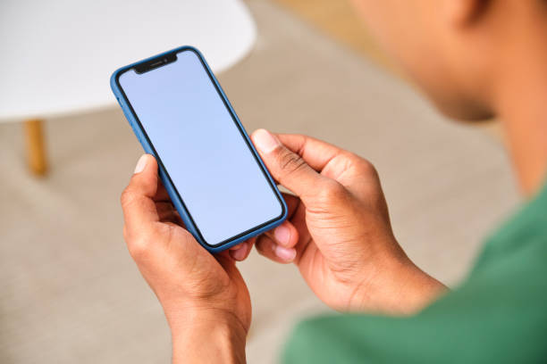 istock A man is holding a cell phone with a blank screen. 2148192810