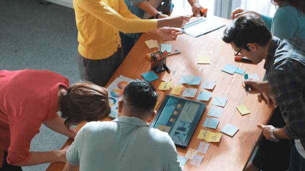 istock Top view of manager writing idea on sticky notes and explain idea. Symposium. 2148192947