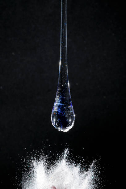 istock Blue transparent glass drop on black background 2148193956
