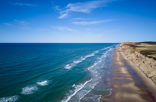 Aerial view of picturesque seascape and majestic mountain with horizon in background under blue sky at Hirtshals, Jutland, Denmark