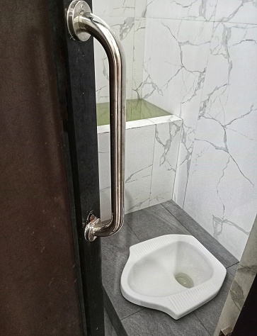 A bathroom with a squat toilet