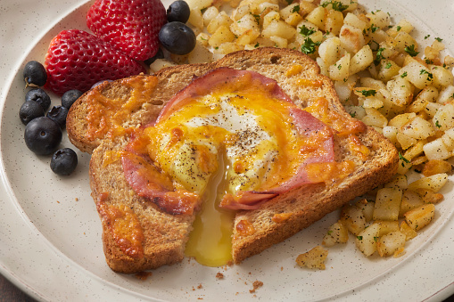 Copycat Air Fryer Egg in a Hole with Ham, Cheddar Cheese, Fruit and Crispy Hash Browns