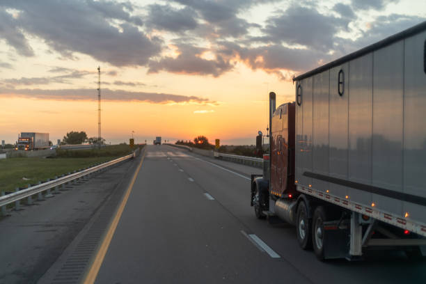 istock Semi truck on the highway at dusk with dramatic sunset in the backdrop. 2148196029