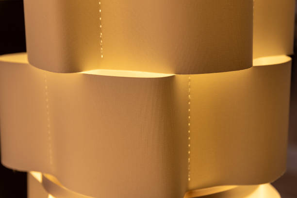 istock Artistic Paper Lamp with Elegant Curves Casting a Warm Glow 2148196037