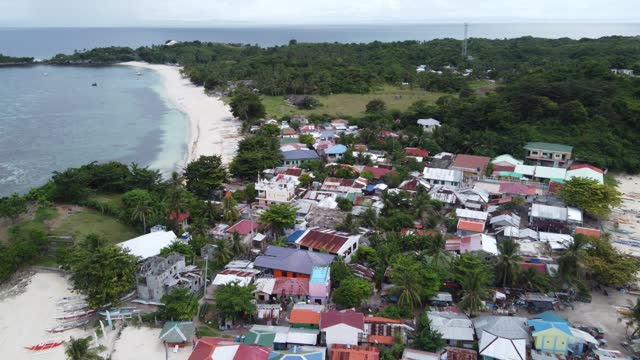 Drone Flyover above Guimbitayan Fishing Village North Of Malapascua Island