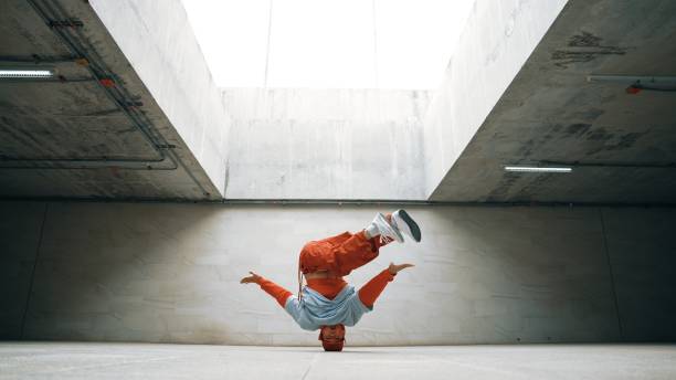 istock Dancing man enjoy practice break dance or freestyle in building. Sprightly. 2148197503