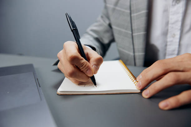 istock man in a gray suit sits in front of a laptop office executive 2148197668