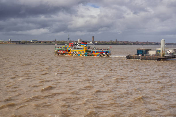 View of the Mersey ferry at the pierhead in the centre of Liverpool, UK. People can be seen on the ferry