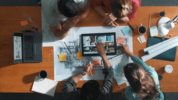 istock Top view of civil engineer using tablet to design house structure. Symposium. 2148198190