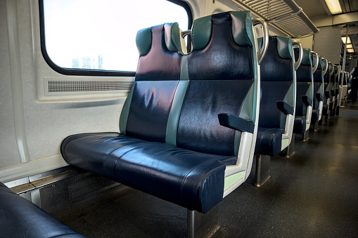 row of seats on a train (long island railroad metro north) leather covered padded chairs