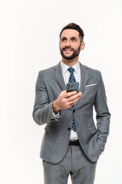 istock Vertical shot of pensive young businessman using smart phone isolated over white background. 2148199454