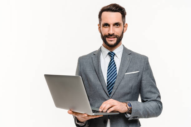 istock Successful young businessman working on laptop isolated over white background. 2148199496