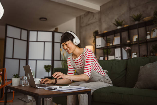 istock Japanese woman work at home with laptop and hold document 2148199683