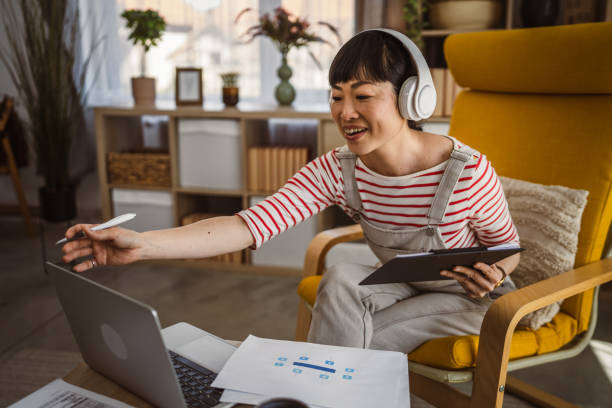 istock Japanese woman work at home with laptop and hold document 2148199868