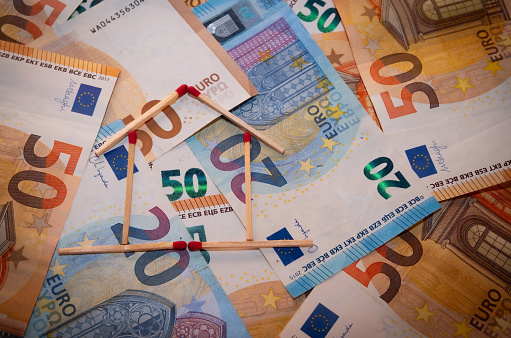 winning concept with euro banknotes and house of matches achieving business goals