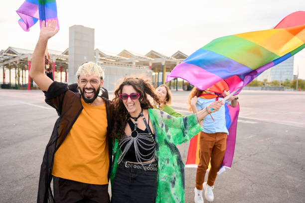 istock A group is happily holding magenta flags, smiling with sky as the backdrop 2148200494