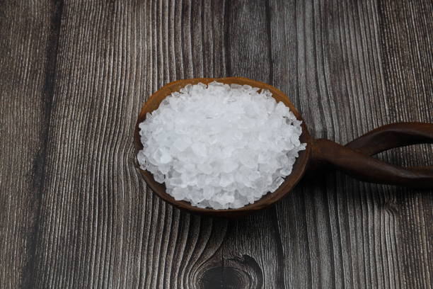 istock sea salt in a spoon isolated on black background 2148200823
