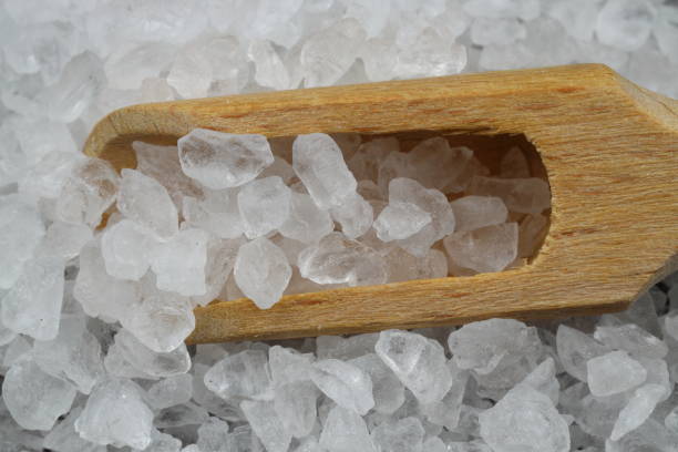 istock sea salt in a spoon isolated on black background 2148200859
