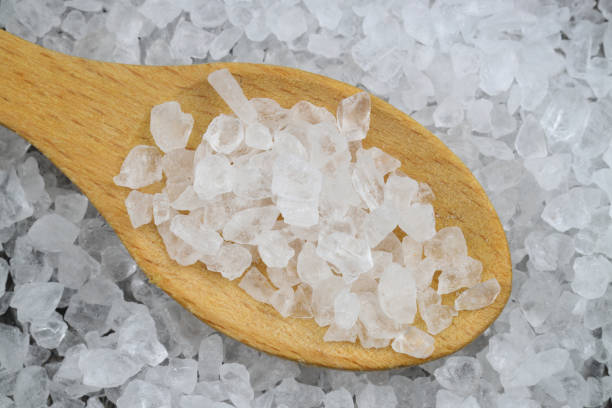 istock sea salt in a spoon isolated on black background 2148200861