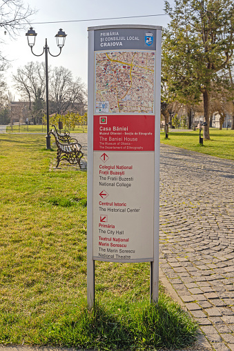 Craiova, Romania - March 16, 2024: Tourist Map With Directions to Attractions and Landmarks at Town Park Spring Day.