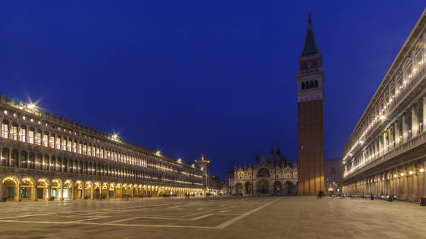 istock An empty illuminated San Marco square with the bell tower and the cathedral at blue hour on a winter evening, Venice, Veneto, Italy 2148202074