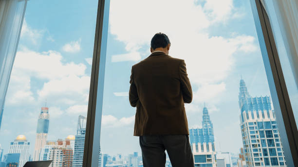 istock Ambitious businessman standing in ornamented office on cityscappe background 2148203219
