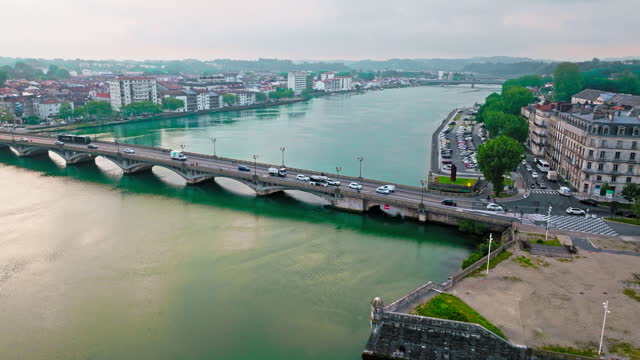 Aerial view of Bayonne city in Basque Country region by the river. Narrow medieval streets and red rooftop buildings.
