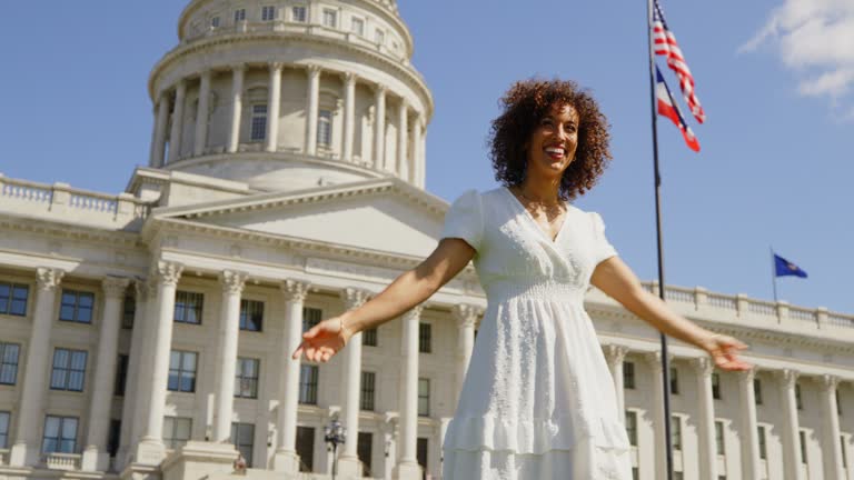 Happy Woman in Front of a State Capitol Building