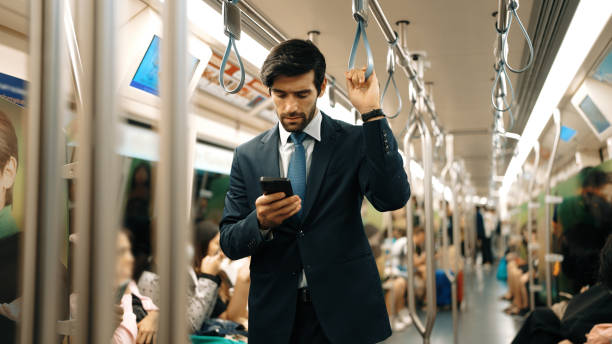istock Professional smart business man looking phone while standing at train.Exultant. 2148208797