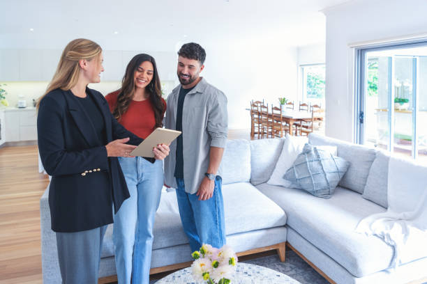 istock Real estate agent or architect showing a couple a new home. 2148208865