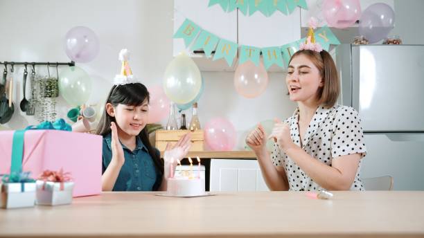 istock Happy daughter and mother singing birthday song while clapping hand. Pedagogy. 2148209270