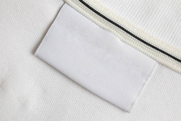 istock Blank white laundry care clothes label on white shirt fabric texture background 2148209835